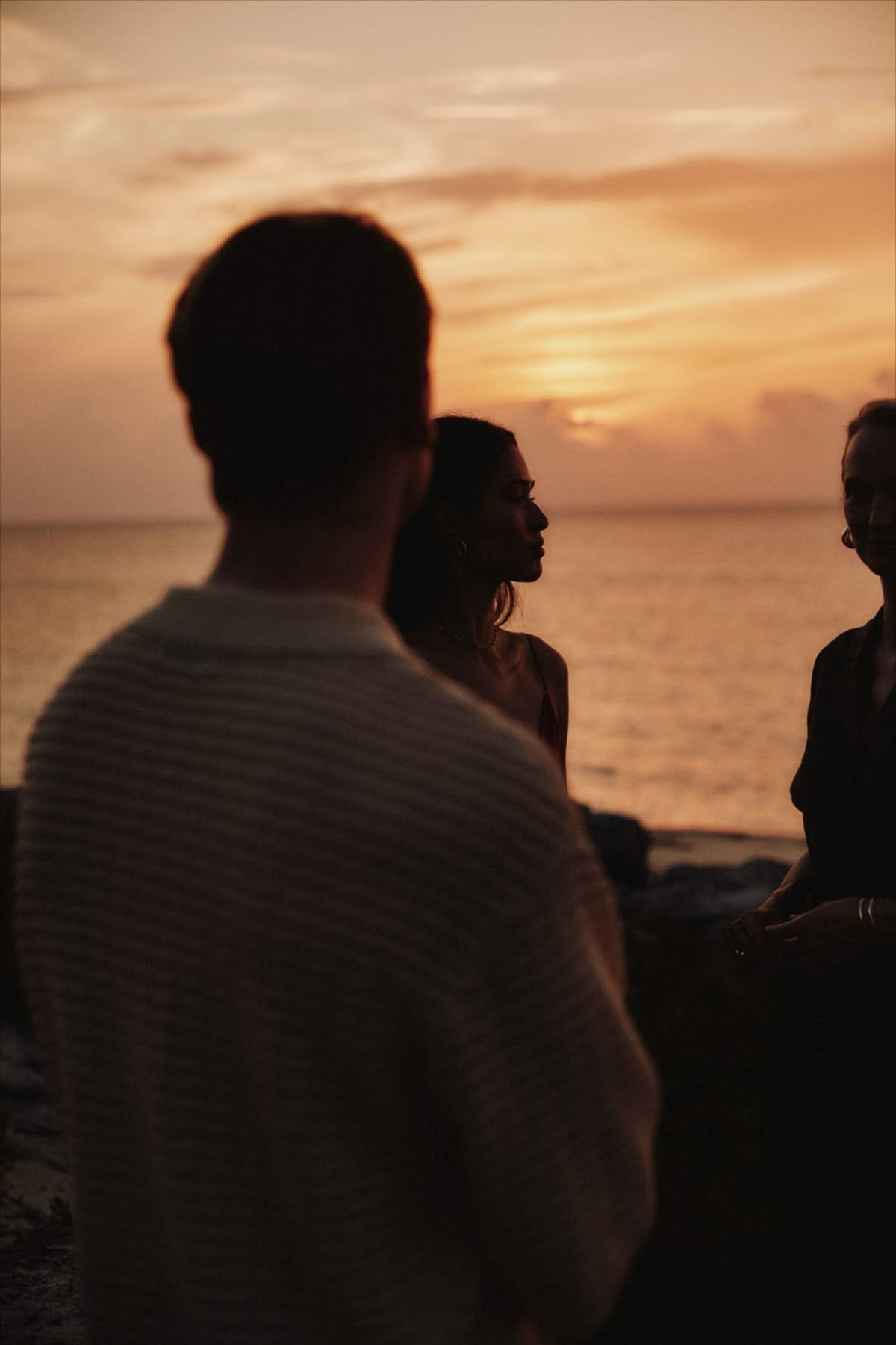 Guests watching the sunset over the sea